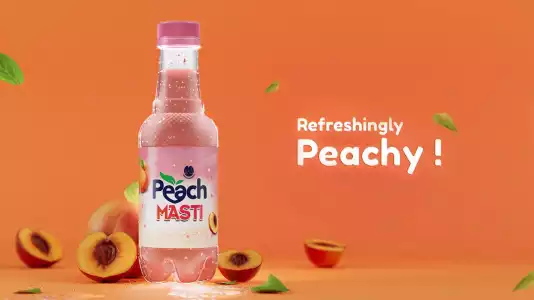 Bottle of Peach Masti in an orange background with text Refreshing Peachy with cut peach sorrounded to it with cinematic aesthetic.