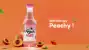 Bottle of Peach Masti in an orange background with text Refreshing Peachy with cut peach sorrounded to it with cinematic aesthetic.